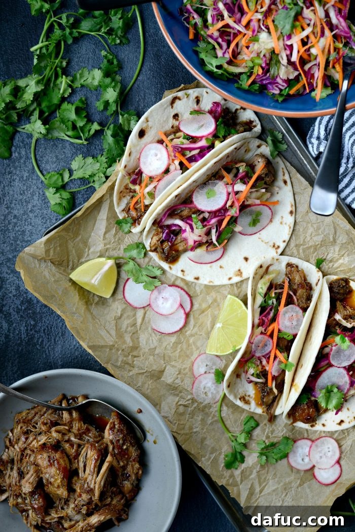 Korean Braised Pork Tacos 2 Braised Korean Pork Tacos - A delicious blend of sweet and spicy pulled pork in soft tortillas with fresh cilantro slaw and radishes.