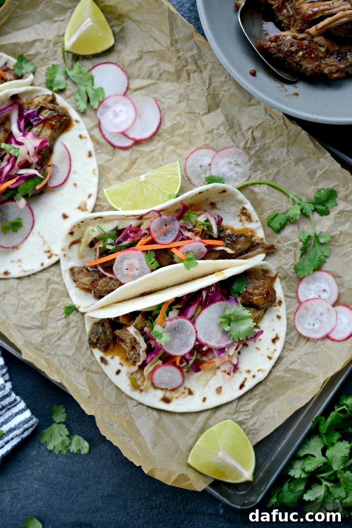 Korean Braised Pork Tacos 7 Beautifully assembled Braised Korean Pork Tacos with cilantro slaw, radishes, and a lime wedge, ready to be enjoyed.