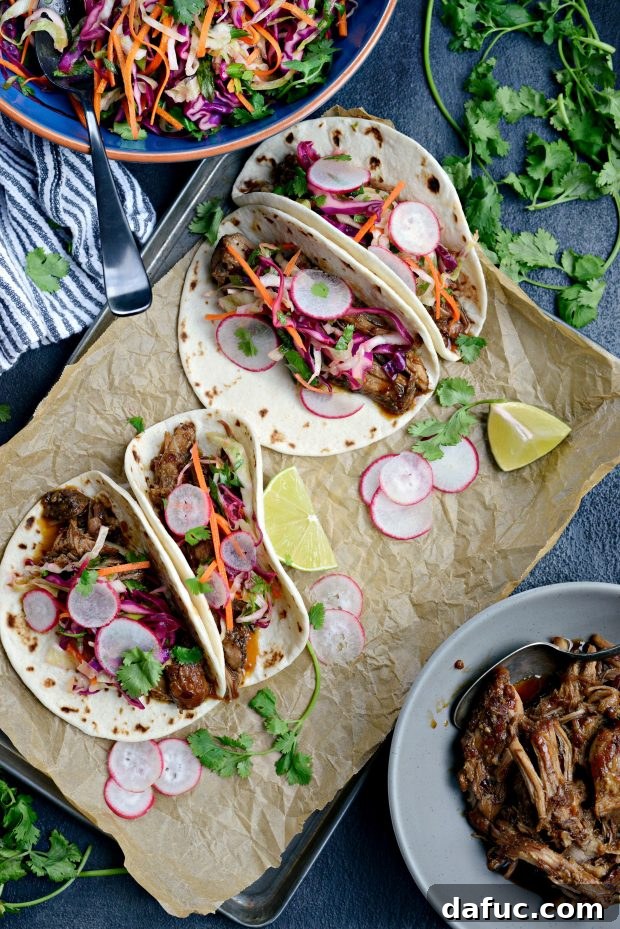 Korean Braised Pork Tacos 8 Close-up of a Braised Korean Pork Taco, showcasing the rich pulled pork and fresh toppings inside a warm tortilla.