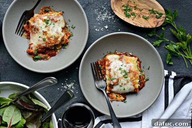 Close-up of baked lasagna roll-ups with melted cheese, fresh from the oven