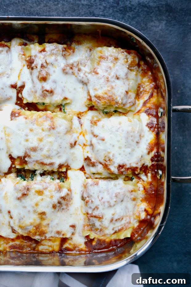 The golden brown, bubbly surface of freshly baked lasagna roll-ups
