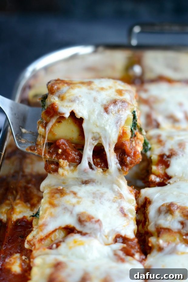 Close-up of stringy melted cheese on a baked lasagna roll-up, showing its irresistible texture