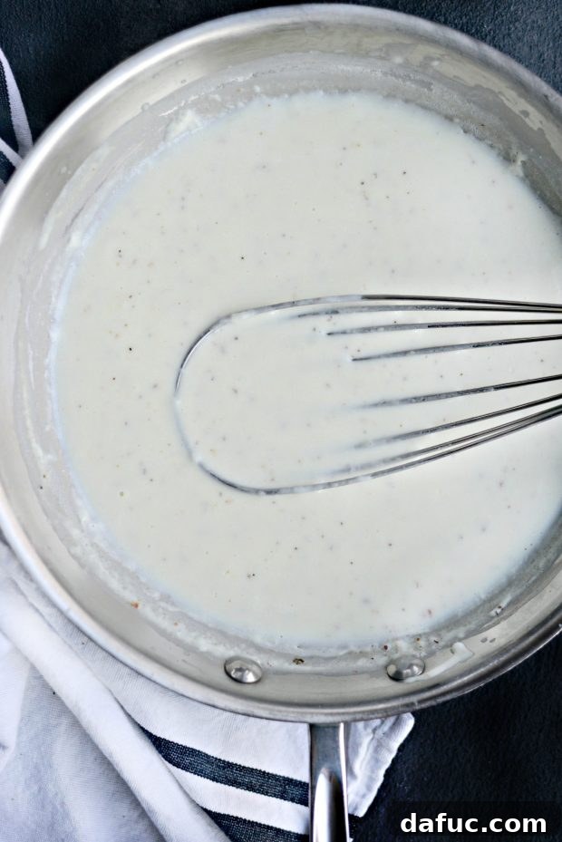 Ingredients for béchamel sauce: butter, flour, milk, and spices on a countertop