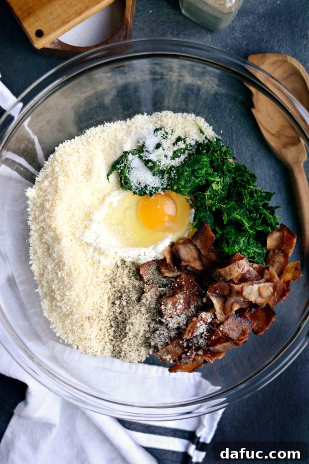 Ingredients for the lasagna filling: ricotta cheese, spinach, bacon, Parmesan, and egg in a bowl