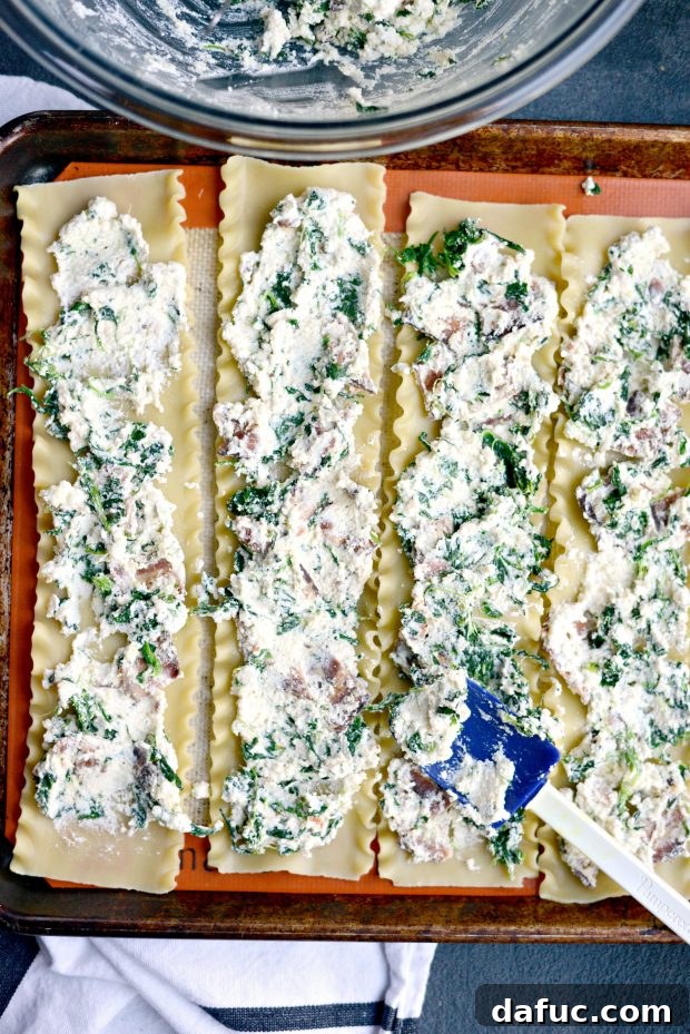 Spreading ricotta mixture evenly onto a cooked lasagna noodle