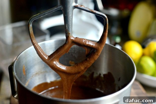 Smooth and rich chocolate cake batter in a stand mixer bowl