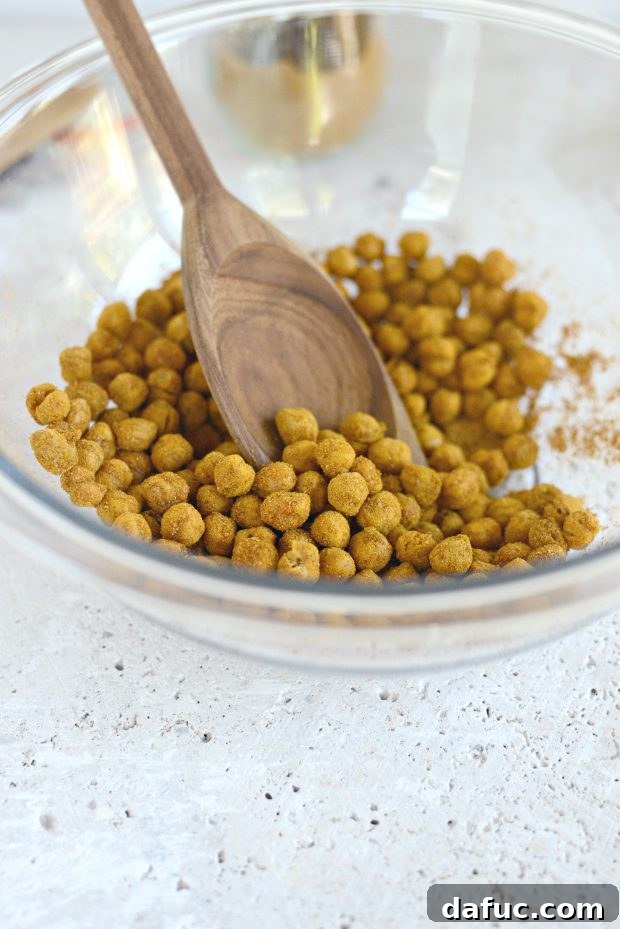 Vibrant Tandoori Roasted Chickpea and Squash Buddha Bowl 4 Chickpeas being tossed with vibrant tandoori spice blend