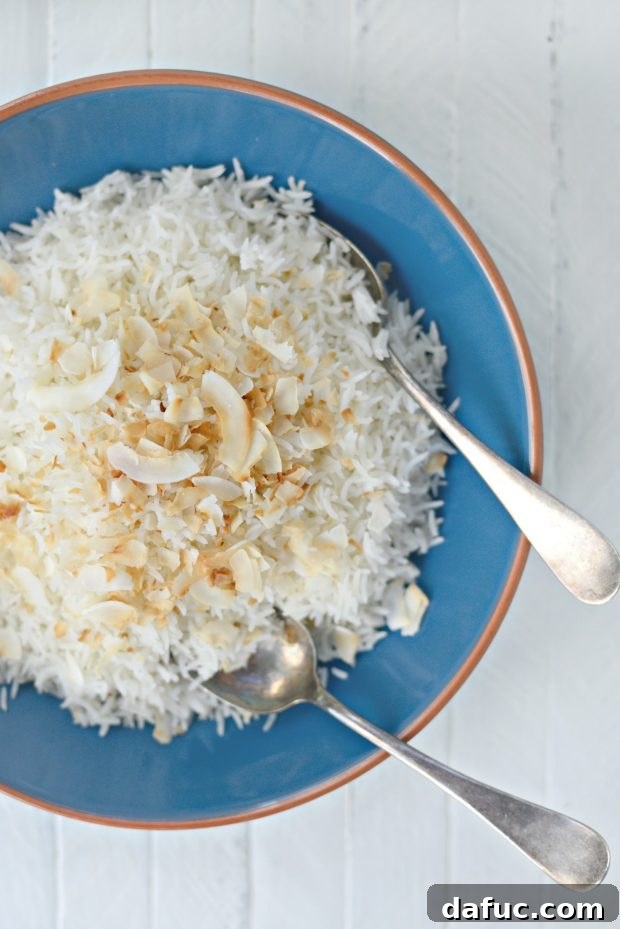 Effortless Rice Cooker Coconut Rice 8 Rice Cooker Coconut Rice, beautifully plated in a white bowl, garnished with toasted coconut flakes.