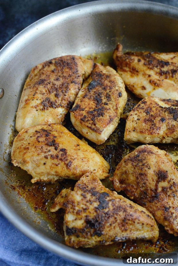 Chicken in skillet - Raw chicken cutlets seasoned and ready to be cooked in a hot skillet.