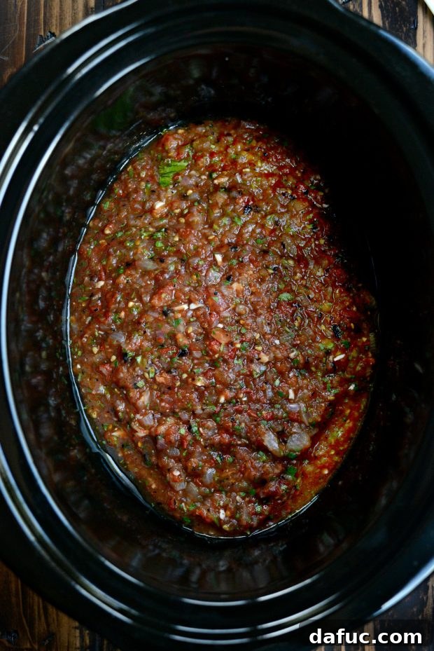 Pouring salsa into the bottom of a slow cooker