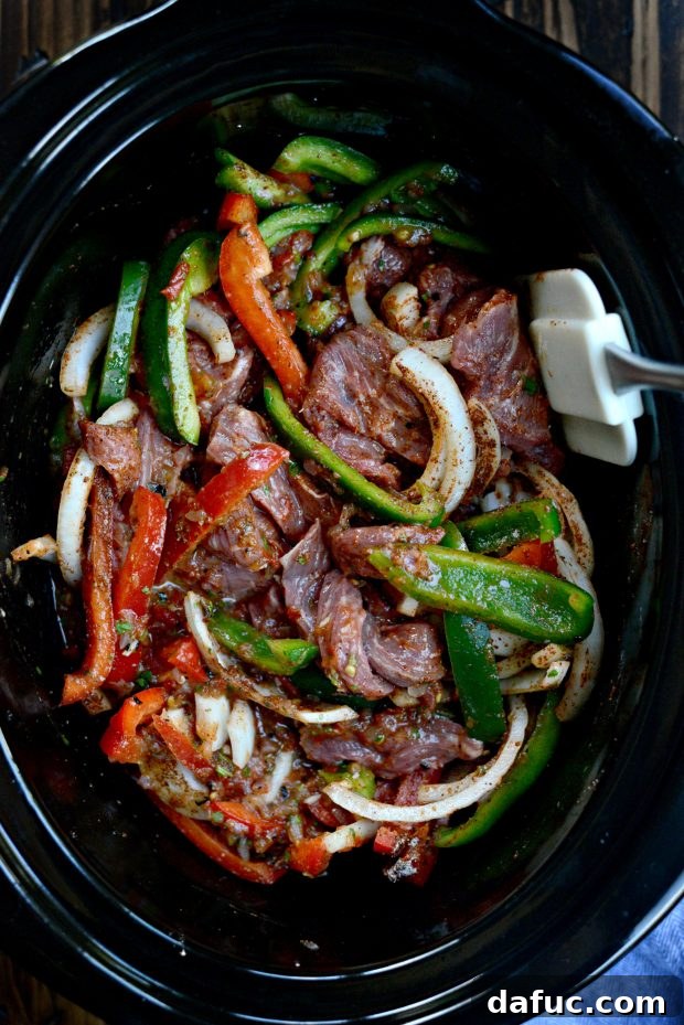 Tossing the ingredients in the slow cooker to combine them with salsa and seasoning