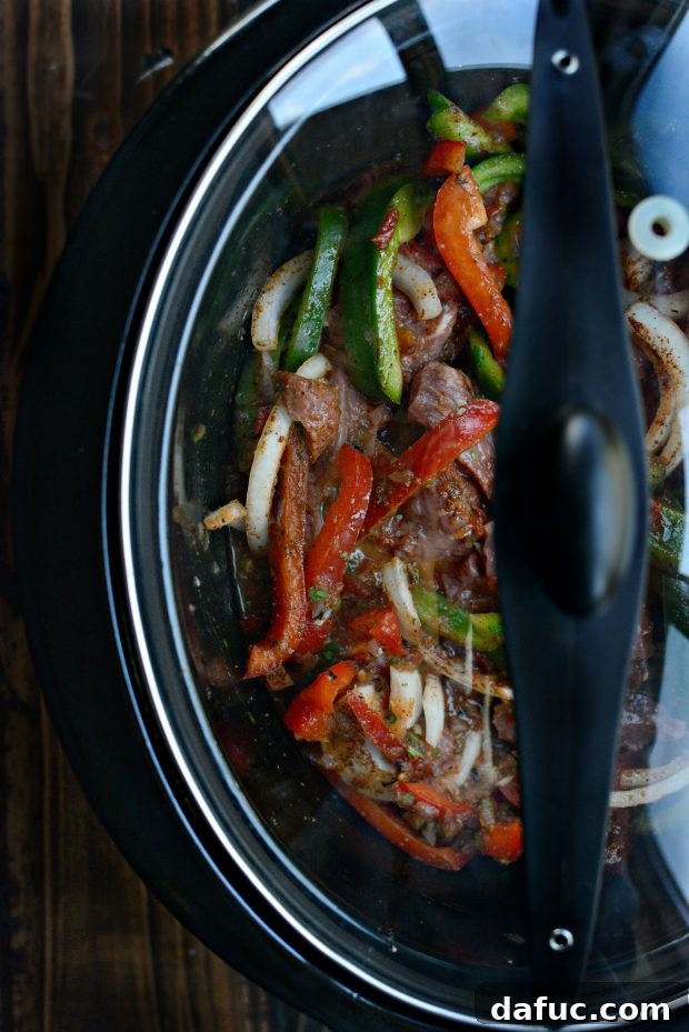 Slow cooker lid on, cooking fajitas