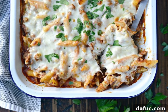 Italian Sausage Mostaccioli baked in a dish with melted cheese