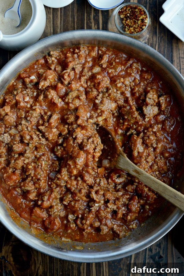 Stirring meat sauce ingredients to combine them