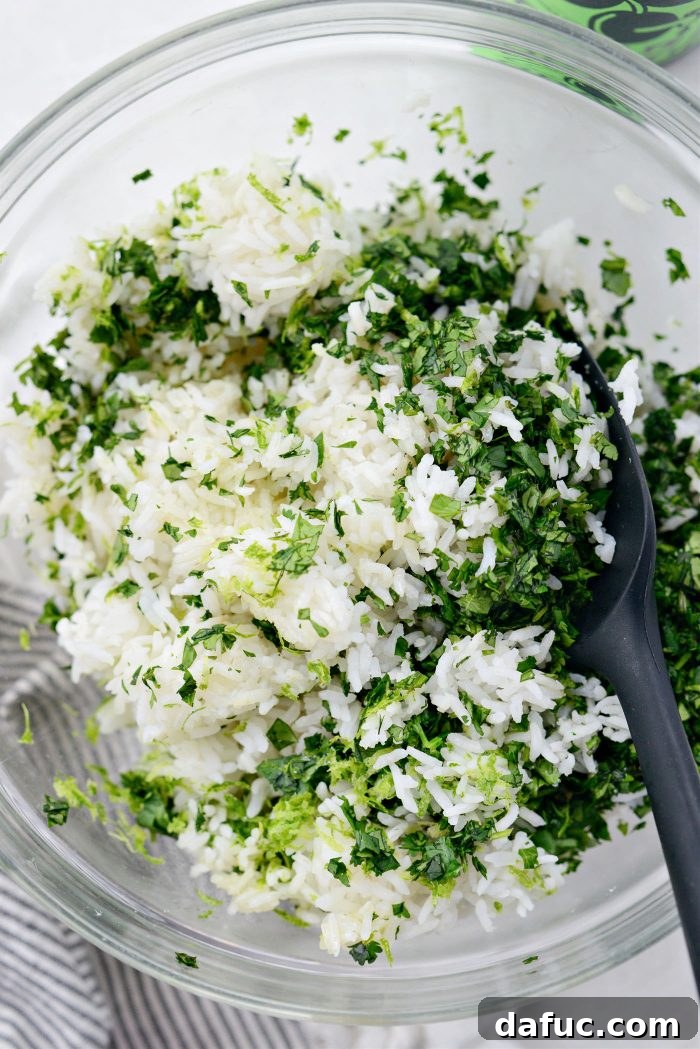 Gently tossing cilantro lime rice ingredients in a bowl