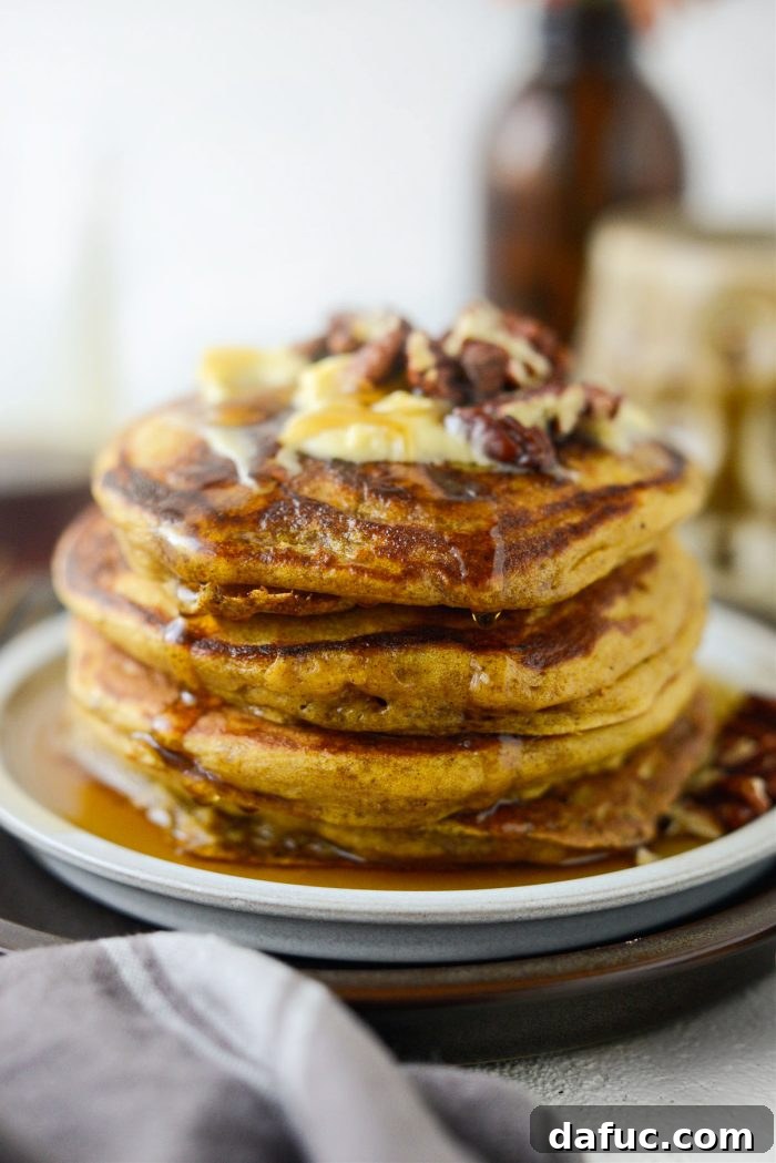 Spiced Brown Butter Pumpkin Pancakes 2 A beautifully stacked plate of Brown Butter Pumpkin Pancakes drizzled with maple syrup, ready to be enjoyed.