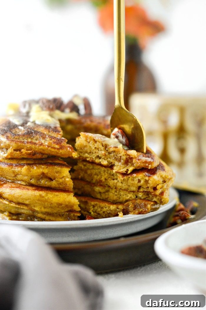 Spiced Brown Butter Pumpkin Pancakes 16 A rustic presentation of Brown Butter Pumpkin Pancakes, artfully arranged on a wooden board, emphasizing their homey and inviting appeal.
