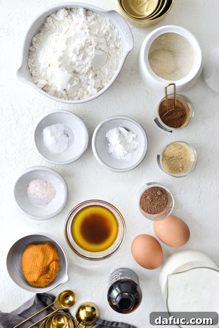 Spiced Brown Butter Pumpkin Pancakes 4 A curated collection of fresh ingredients for Brown Butter Pumpkin Pancakes, including flour, spices, pumpkin puree, and buttermilk, arranged aesthetically.