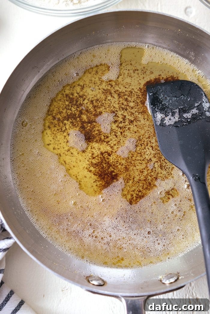 Spiced Brown Butter Pumpkin Pancakes 5 A small pan with golden-brown butter, showcasing the delicious caramelized milk solids, ready for adding to the pancake batter.