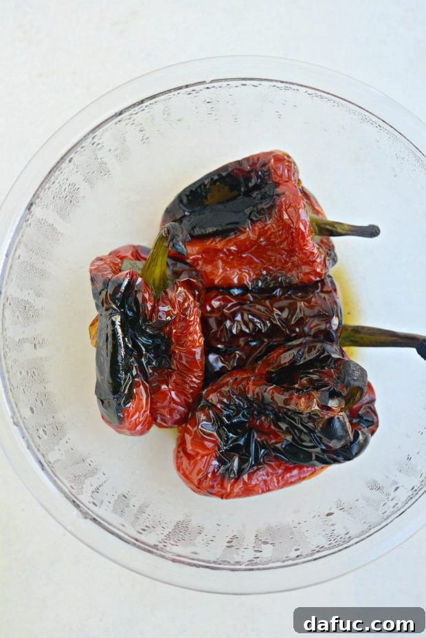 Transfer roasted red peppers to boil and cover with plastic wrap to steam