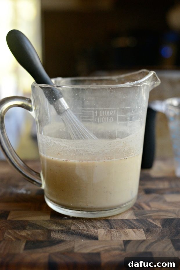 Whisking gravy ingredients in a liquid measuring cup