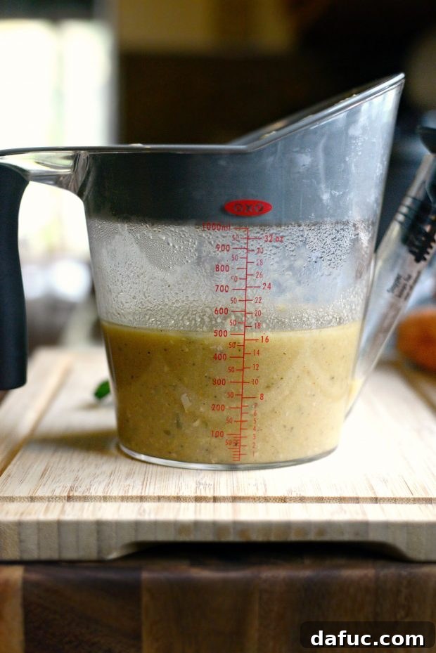 Finished slow cooker pork chops with herb gravy in a serving dish