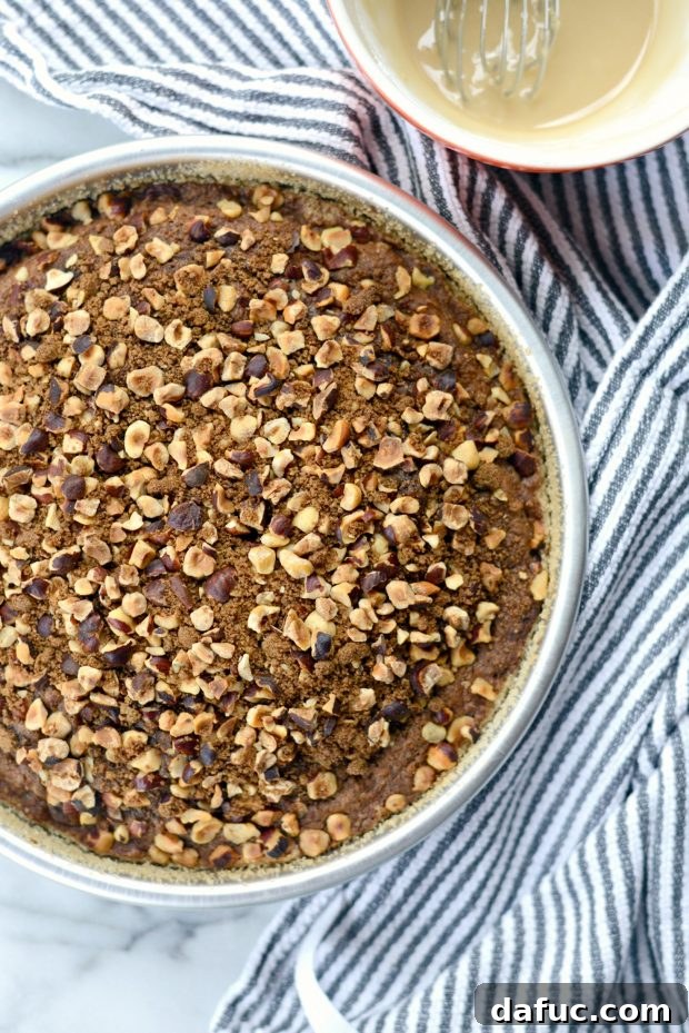 Freshly baked pumpkin coffee cake with hazelnut streusel, cooling on a wire rack