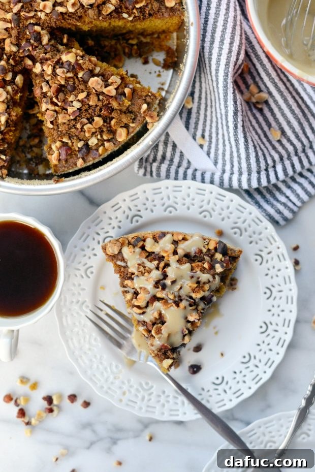 Drizzling homemade maple glaze over slices of warm pumpkin coffee cake