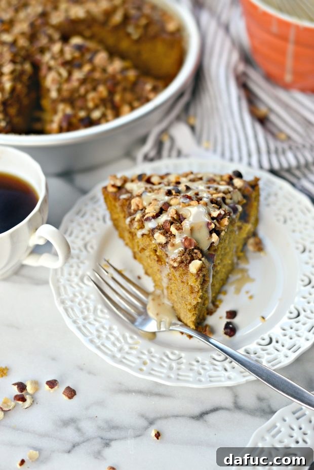 Close-up of a slice of Pumpkin Coffee Cake with Hazelnut Streusel, showing the moist cake texture