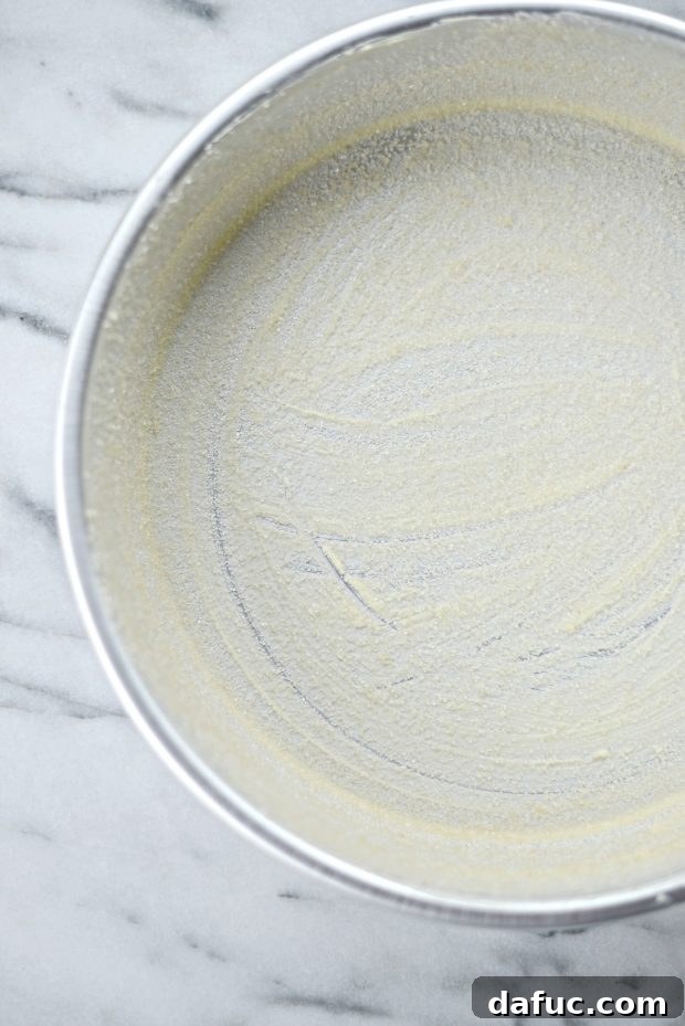 Butter a cake pan and dust with sugar before adding batter