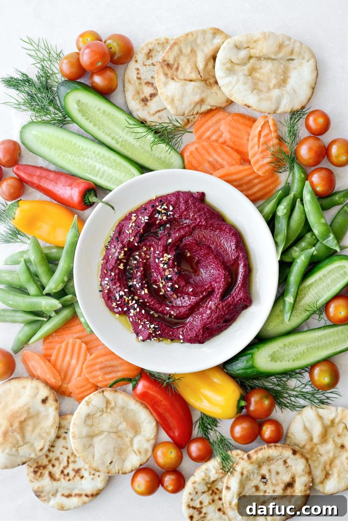 Vibrant Roasted Beet Hummus 12 A beautifully garnished bowl of Roasted Beet Hummus, topped with everything seasoning and a drizzle of olive oil