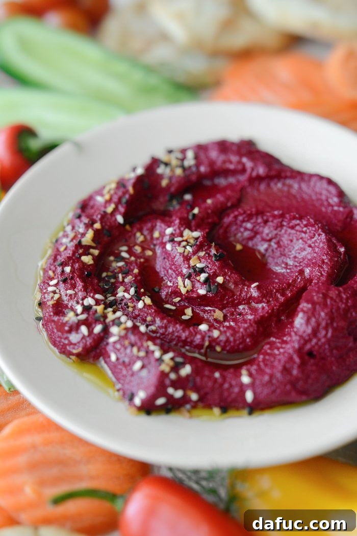 Crimson Root Hummus 14 A bowl of Roasted Beet Hummus with various dipping items