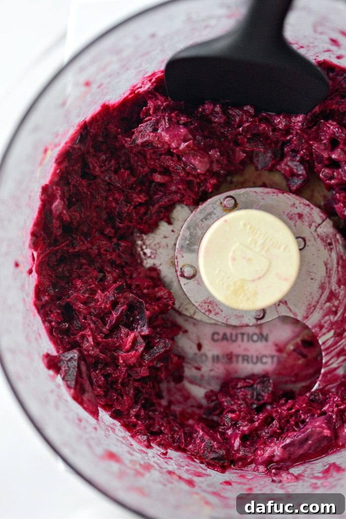 Crimson Root Hummus 10 Scraping down the sides of a food processor bowl during blending