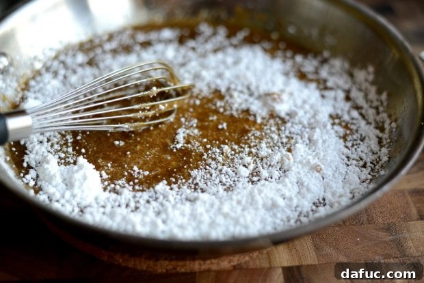 Whisking glaze ingredients in a skillet