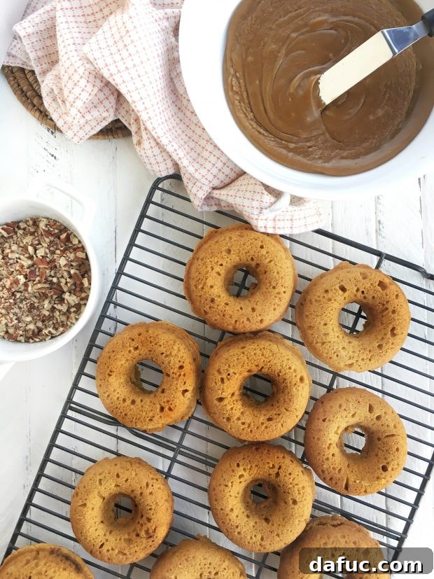 Glazing a baked pumpkin doughnut with brown sugar maple glaze