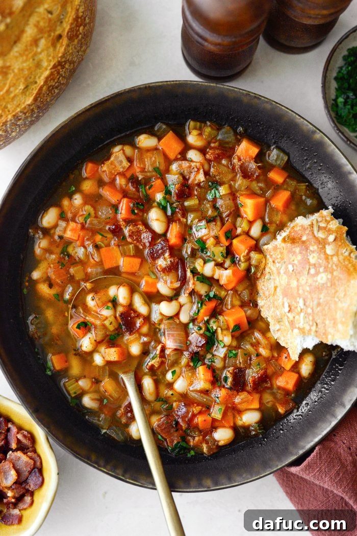 Smoky Bean and Bacon Delight 2 Delicious Homemade Bean and Bacon Soup in a rustic bowl, garnished with fresh parsley.