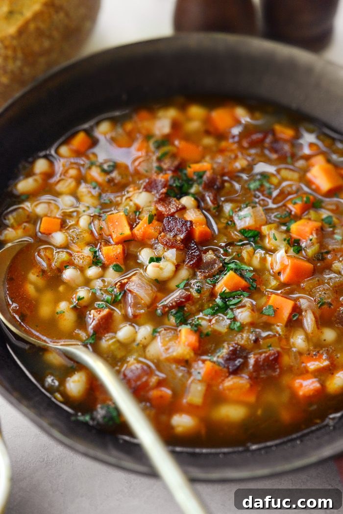 Smoky Bean and Bacon Delight 3 Close-up of hearty Homemade Bean and Bacon Soup, showing the perfect blend of navy beans, crispy bacon, and colorful vegetables.