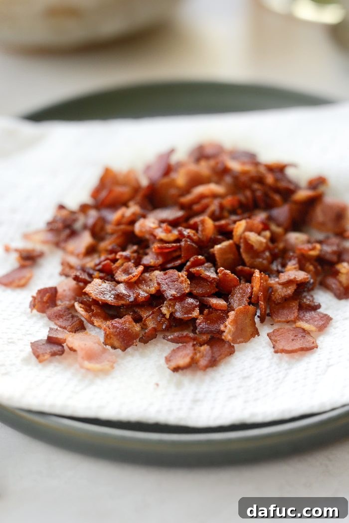 Smoky Bean and Bacon Delight 7 Using a slotted spoon to transfer crispy bacon to a paper towel-lined plate, a crucial step for managing fat and preserving texture.