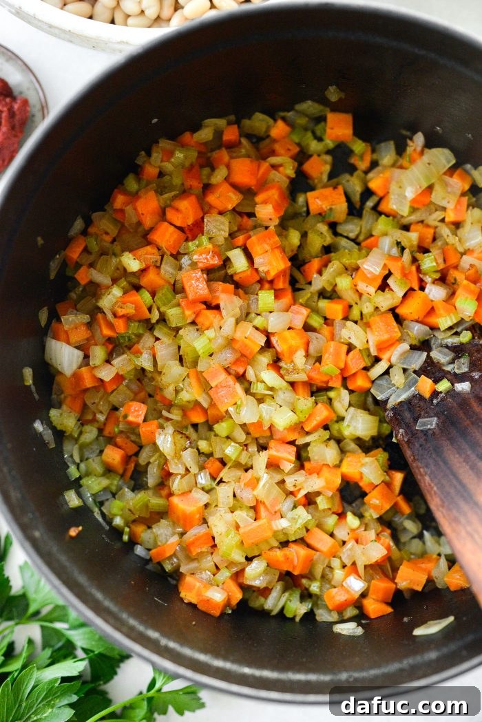 Smoky Bean and Bacon Delight 10 Sautéing the colorful medley of vegetables in bacon fat, gently releasing their aromatic essence for the soup.