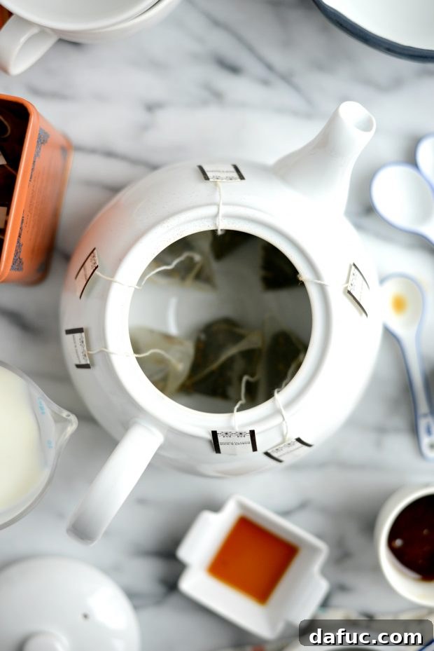 Spiced Comfort Masala Chai 6 Honey and chai spice being added to a saucepan for spiced milk