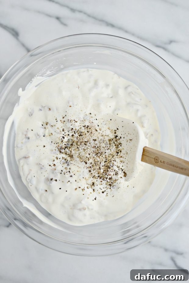 Sweet and Tangy Blue Cheese Shallot Dip 12 The Caramelized Shallot and Blue Cheese Dip in a serving bowl, garnished with extra shallots and blue cheese.