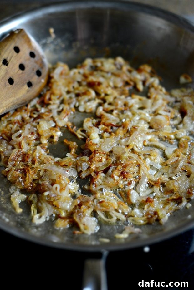 Sweet and Tangy Blue Cheese Shallot Dip 8 Close-up of caramelized shallots cooling in a skillet, showcasing their rich color.