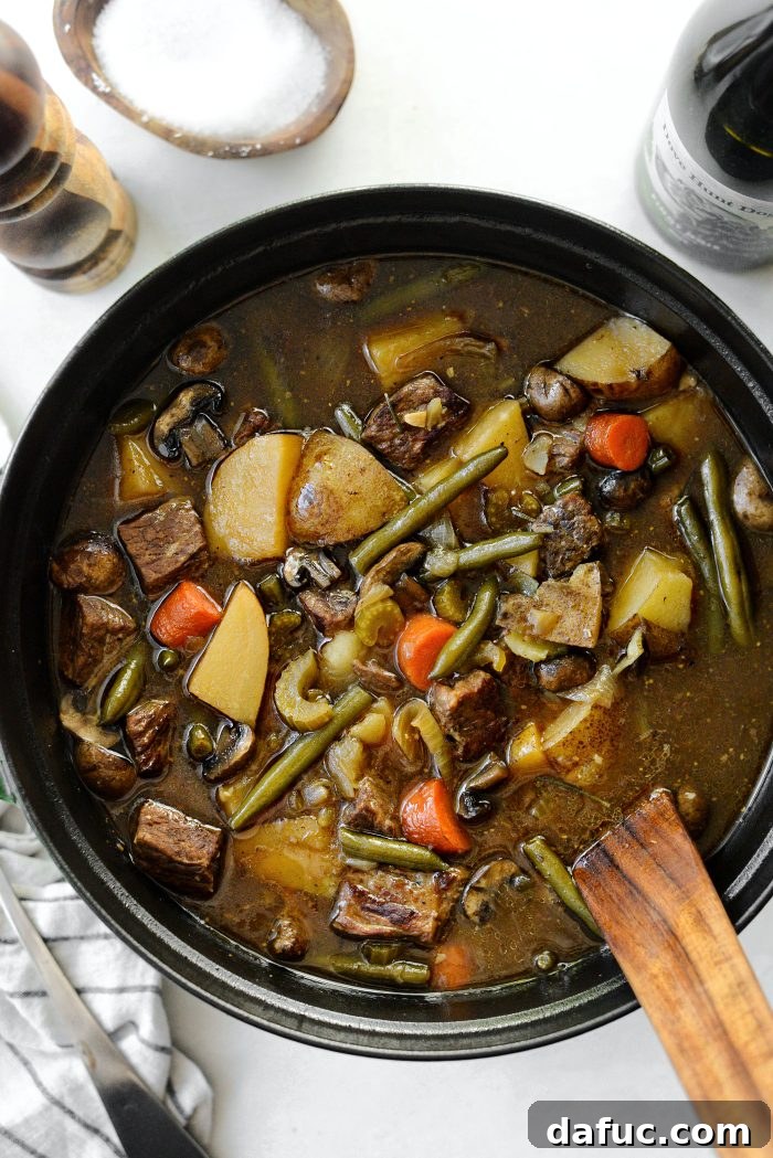 Close up of a spoonful of oven braised beef stew, rich and inviting