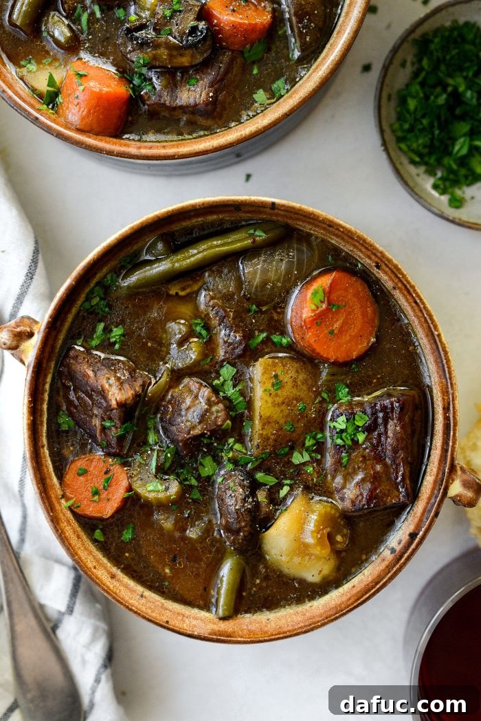 Oven braised beef stew served in a bowl with crusty bread