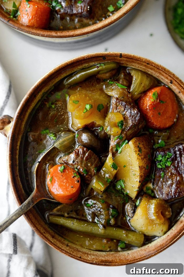 Rustic pot of oven braised beef stew, perfect for chilly weather