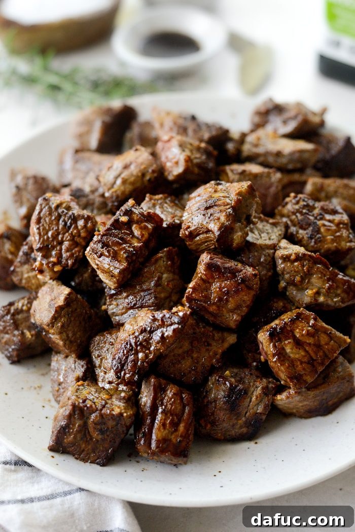 Removing seared beef from the pot to a clean plate
