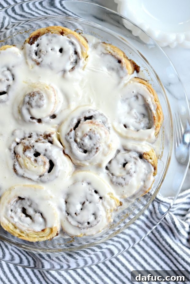 Effortless Yeast-Free Cinnamon Rolls 14 Pouring Icing on Hot Cinnamon Rolls