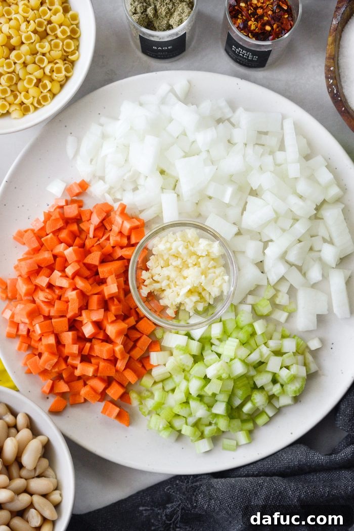 Prepping diced onions, sliced celery, and diced carrots for the soup