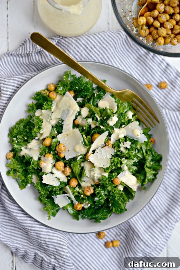 Close-up of a vibrant bowl of Healthy Kale Caesar Salad, highlighting the massaged kale and golden roasted chickpeas.