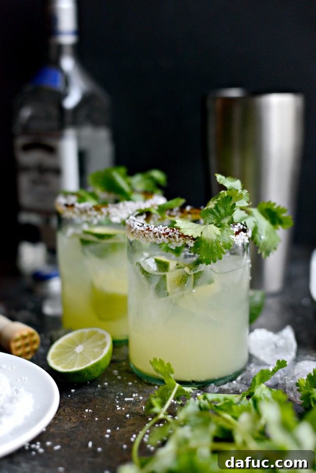 Zesty Cilantro Lime Margaritas 10 Salting the rim of a margarita glass with lime and kosher salt